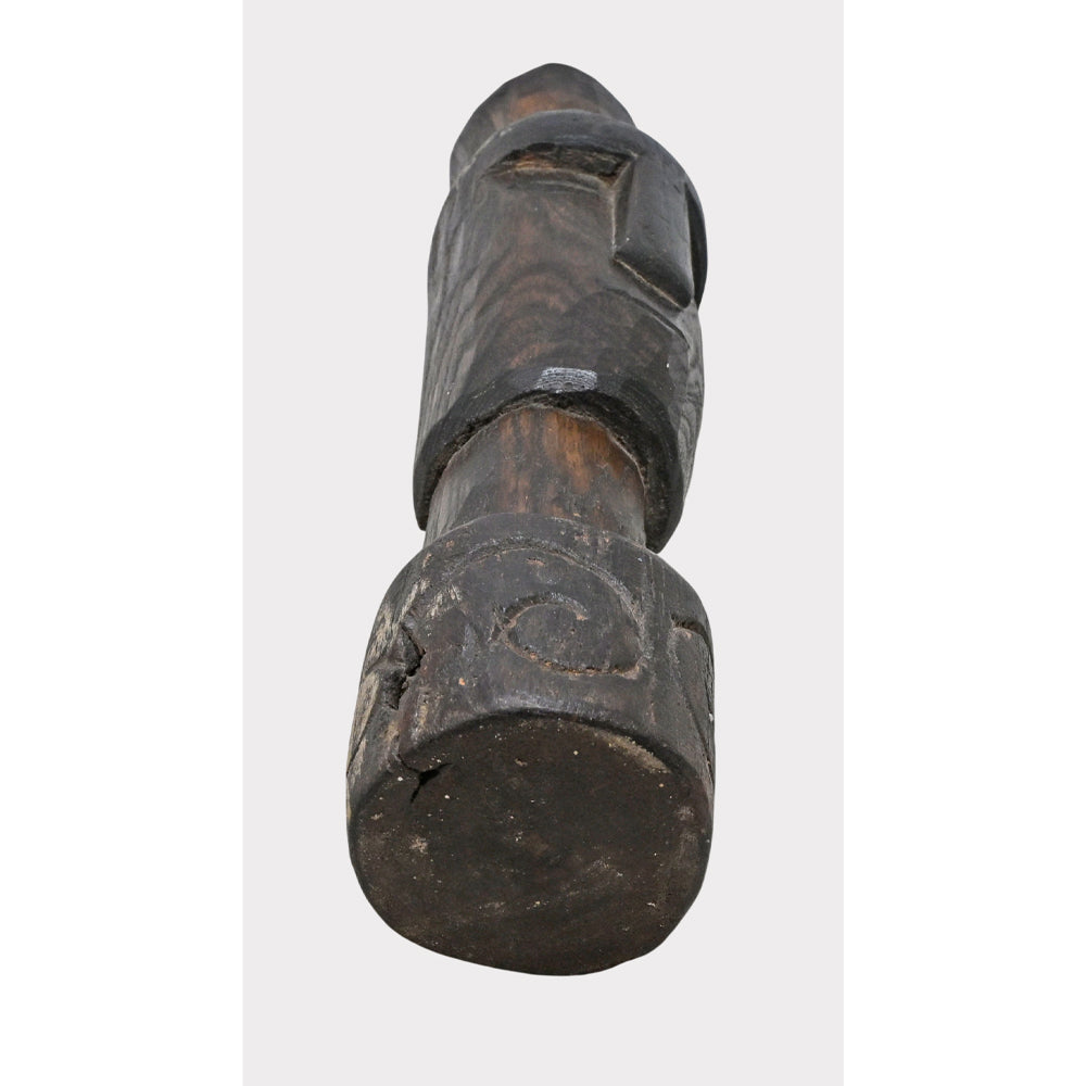 Dark walnut tribal wooden statue, carved texture detail
