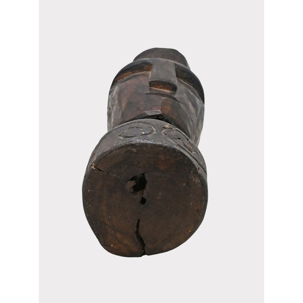 Dark aged wooden tribal face statue, side view