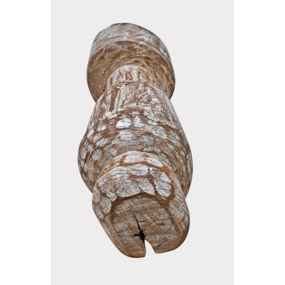 Natural wood tribal statue showing limewashed finish