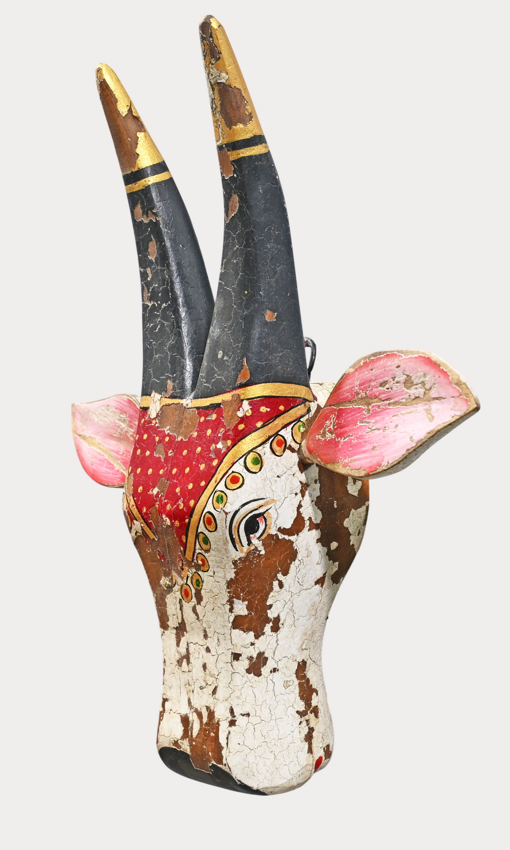 Red and white folk-art cow head wall hanger, detail view