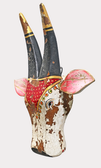 Red and white folk-art cow head wall hanger, detail view