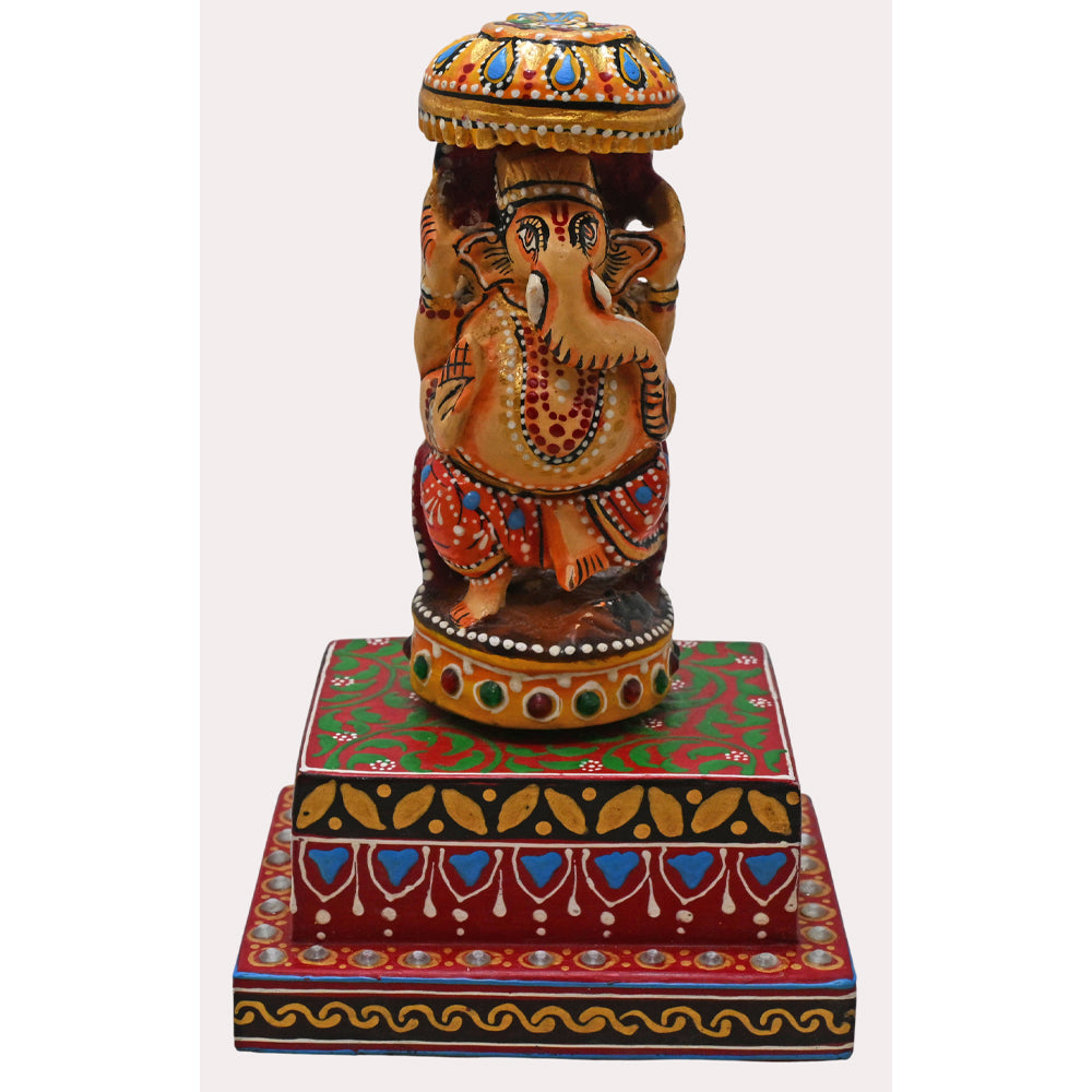 Lord Ganesha idol showing decorative wooden base