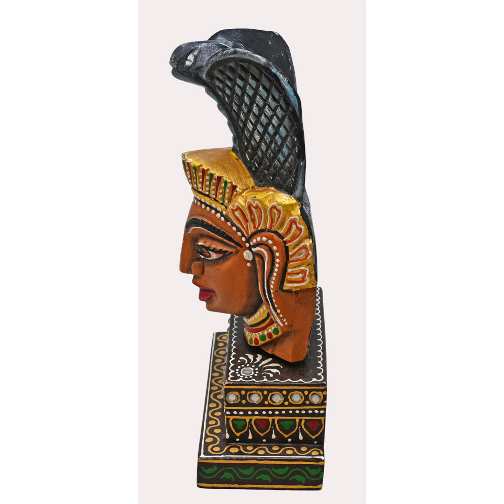 Nag Devta wooden idol with decorative base, side view