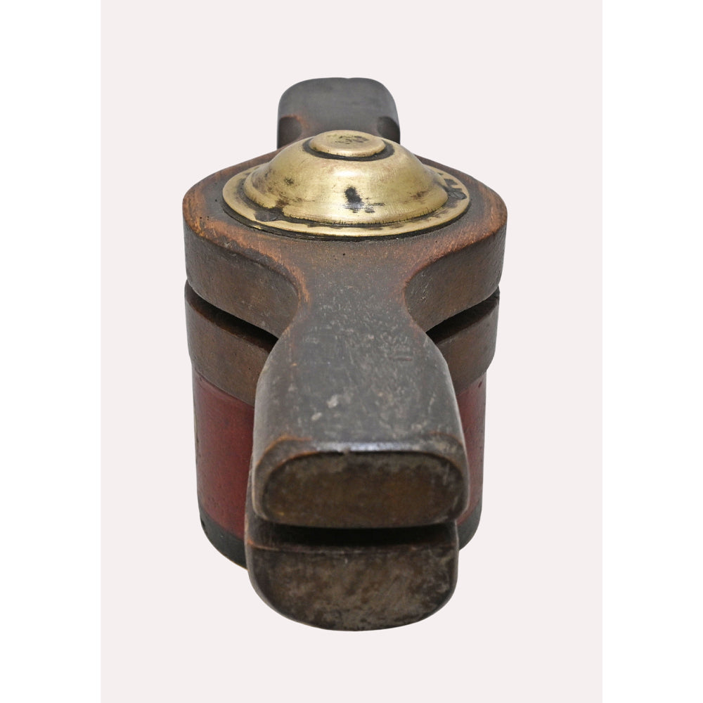 Handcrafted wooden hand juicer with brass work, angled view