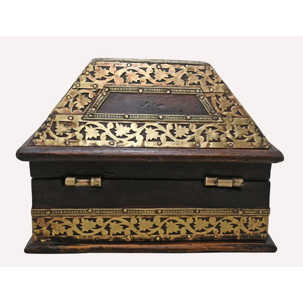 Close-up of brass motifs on dark wooden jewellery chest