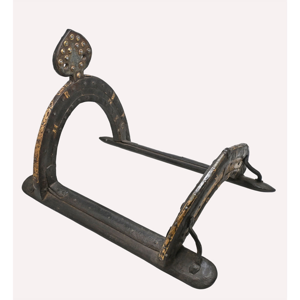 Vintage equestrian saddle with metal detailing, angled view