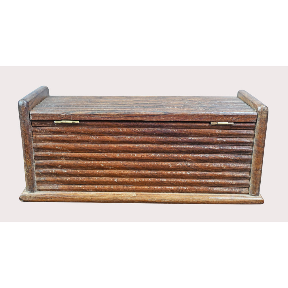 Close-up of gold-toned carved details on pencil box