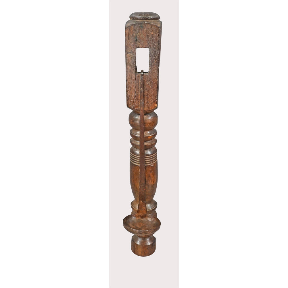 Close-up of hand-forged iron cup on wooden candle holder
