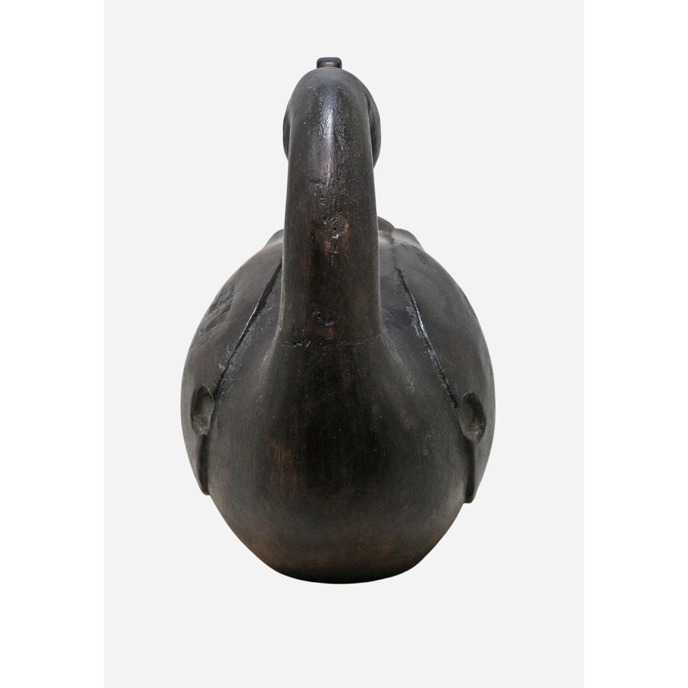 Angled view of colourful handcrafted wooden duck figurine