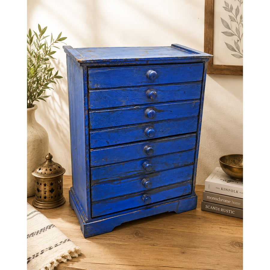 Blue rustic antique wooden storage drawer unit with multiple drawers, front view