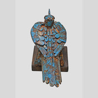 Blue iron bird figurine showing wooden display base