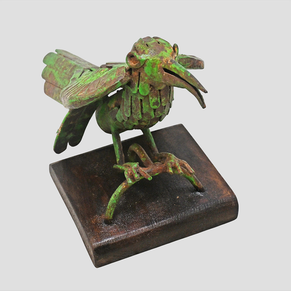 Green antique iron bird sculpture, angled view