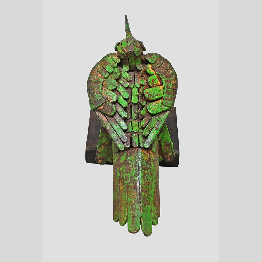 Green iron bird figurine showing wooden base