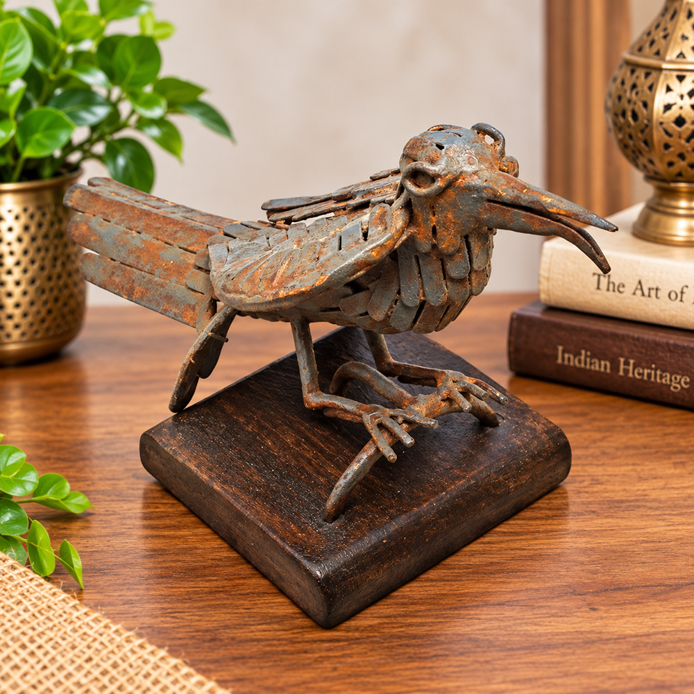 Grey antique iron bird figurine on wooden base, front view