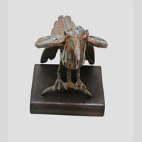 Grey iron bird figurine showing wooden base