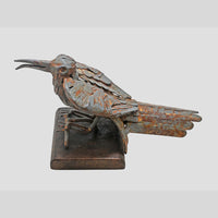 Grey antique iron bird sculpture, angled view
