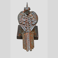 Close-up of metal details on grey antique bird figurine