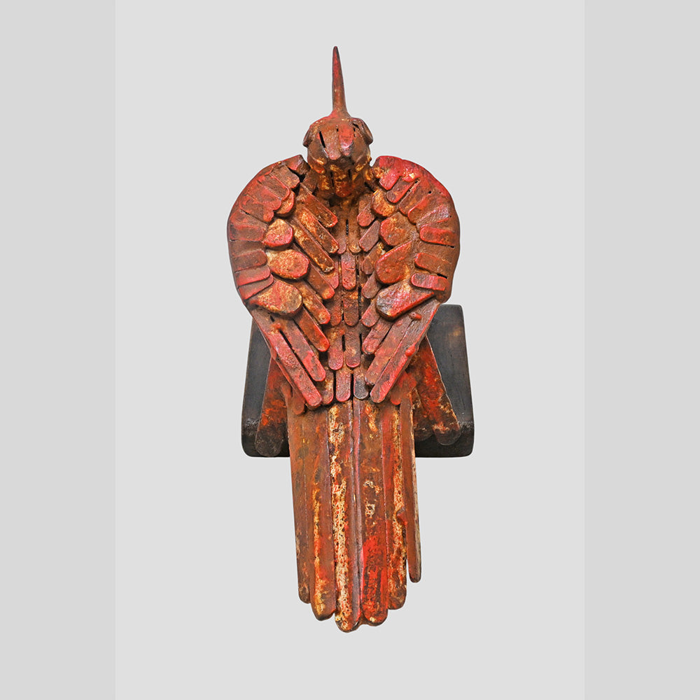 Red iron bird figurine showing wooden base