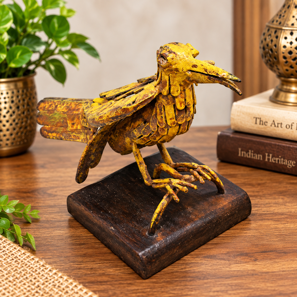 Yellow antique iron bird figurine on wooden base, front view