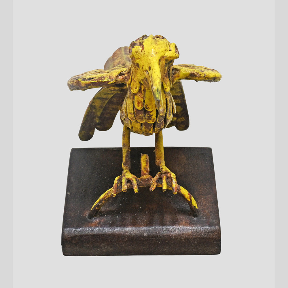 Yellow iron bird figurine showing wooden base