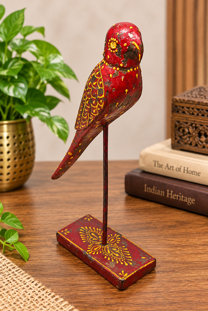 Red and yellow hand-painted wooden bird figurine on stand, front view
