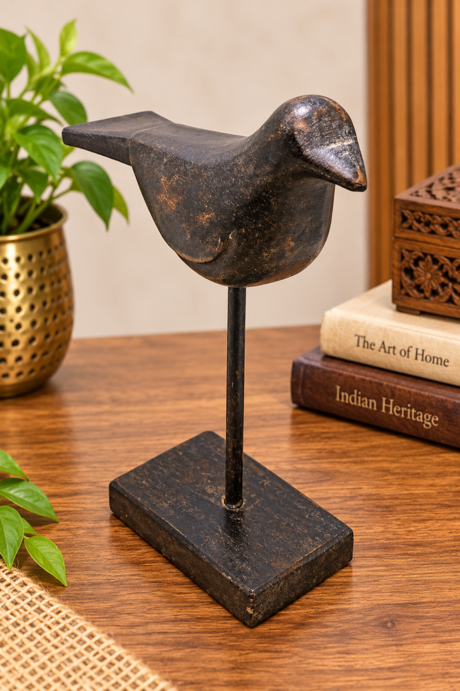 Black antique wooden bird figurine on stand, front view