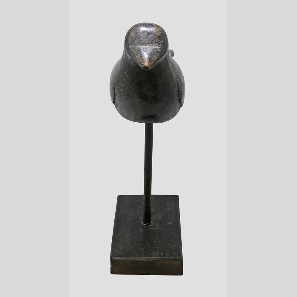 Black antique wooden bird figurine showing side profile