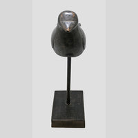 Black antique wooden bird figurine showing side profile