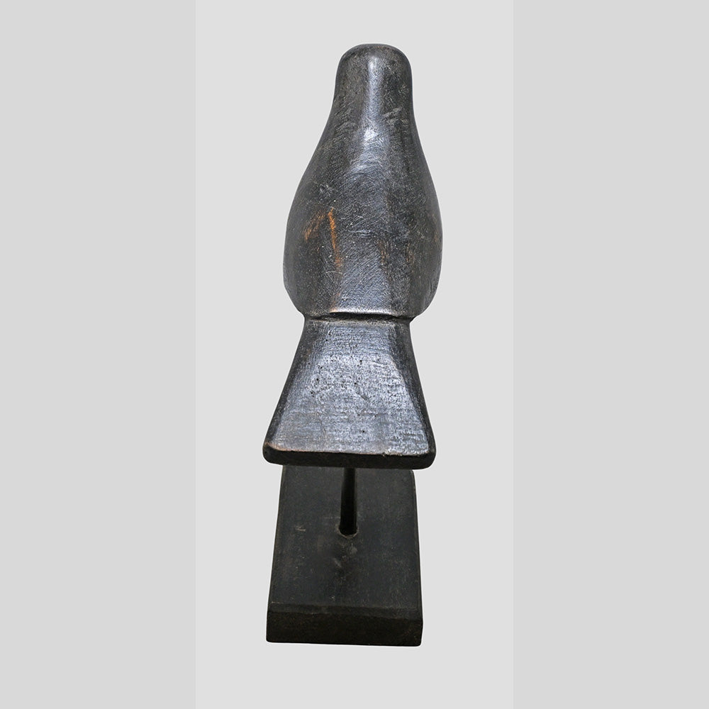 Close-up of handcrafted black wooden bird figurine details