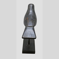 Close-up of handcrafted black wooden bird figurine details