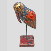 Close-up of painted wing and body details on wooden bird figurine