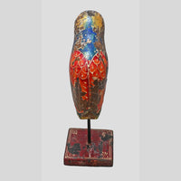 Side view of hand-painted wooden bird with extended tail