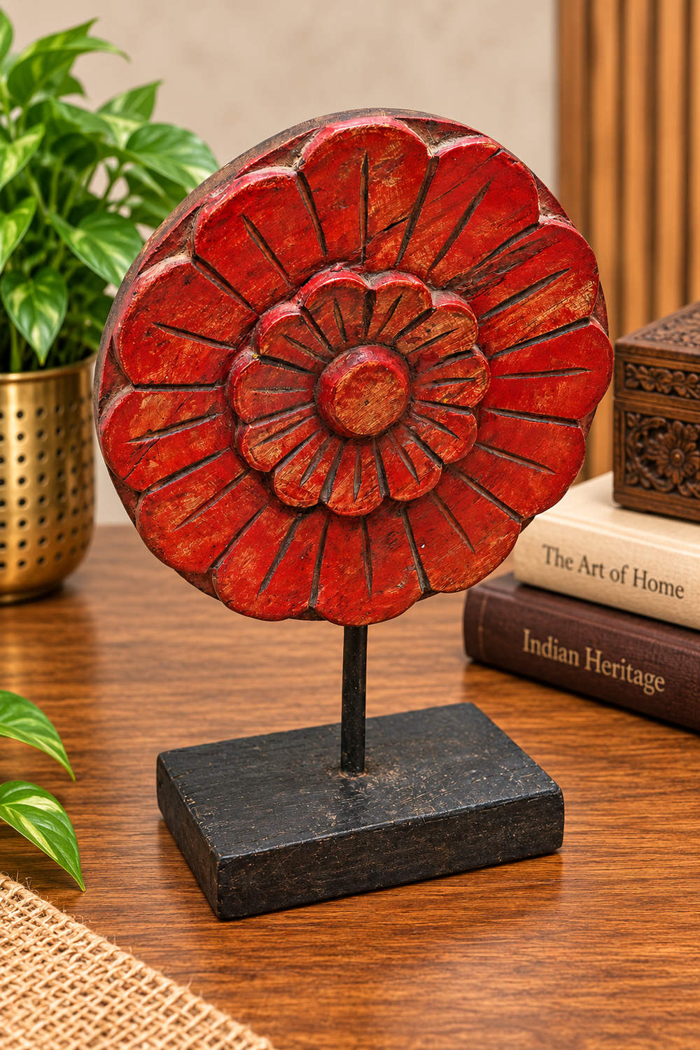 Antique red wooden floral medallion with carved petals on stand, front view