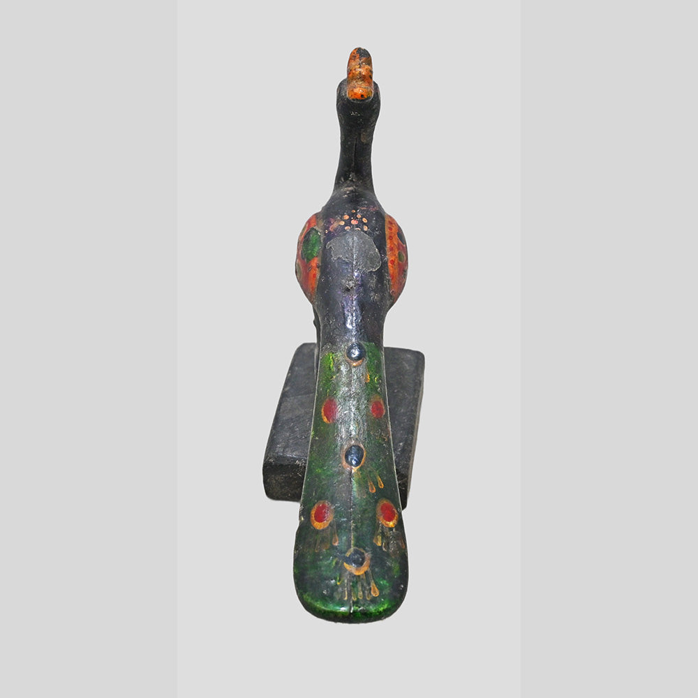Side view of wooden floral medallion mounted on metal support