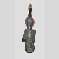 Side view of wooden floral medallion mounted on metal support