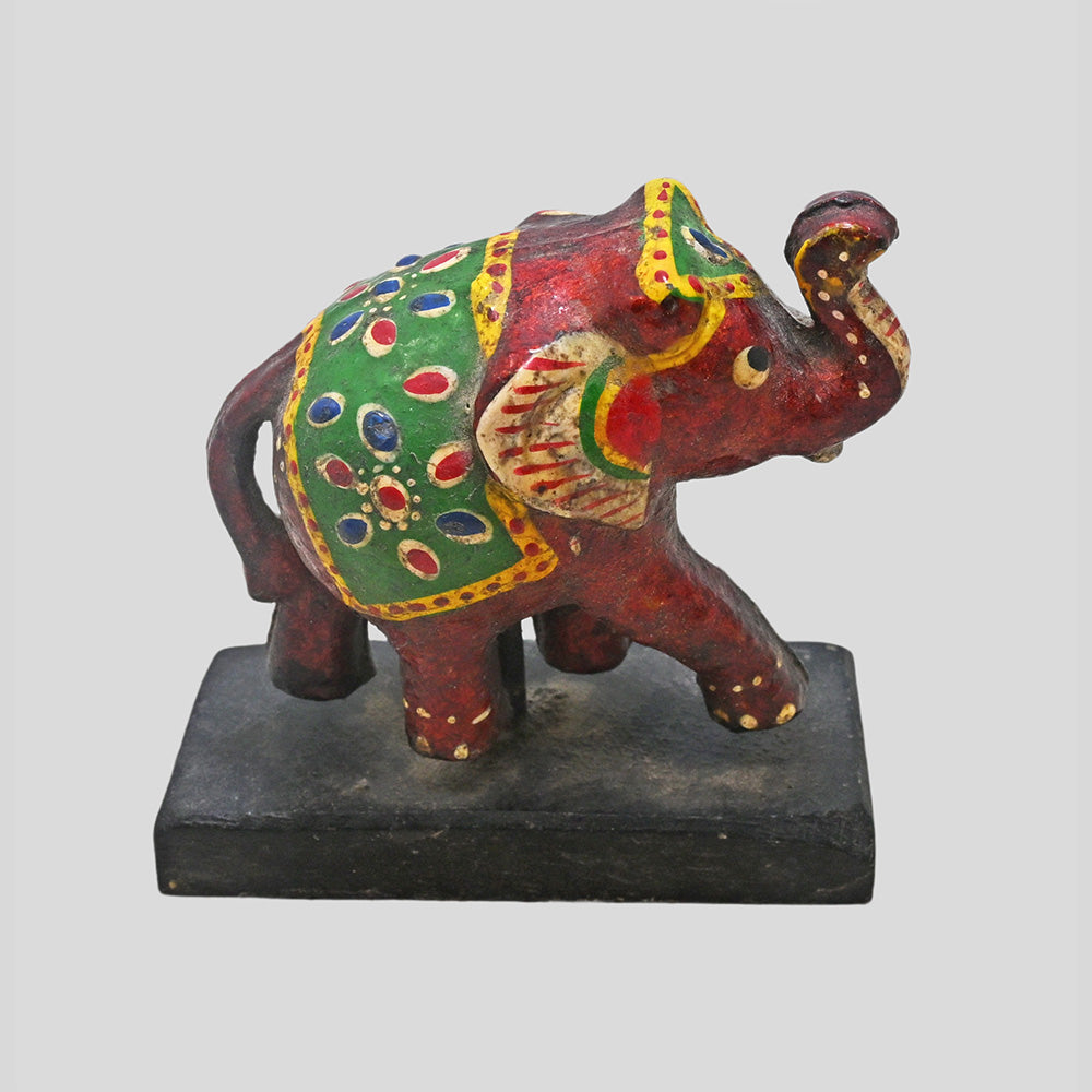 Angled view of multicolor wooden elephant folk art sculpture