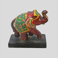 Angled view of multicolor wooden elephant folk art sculpture