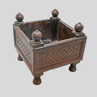 Angled view of antique-style carved wooden storage box