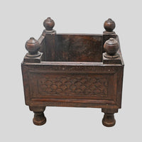Close-up of carved panels on vintage wooden storage box