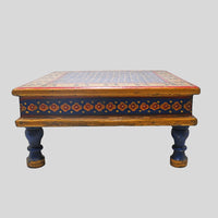 Side view of wooden Bajot Chowki showing painted apron and turned legs