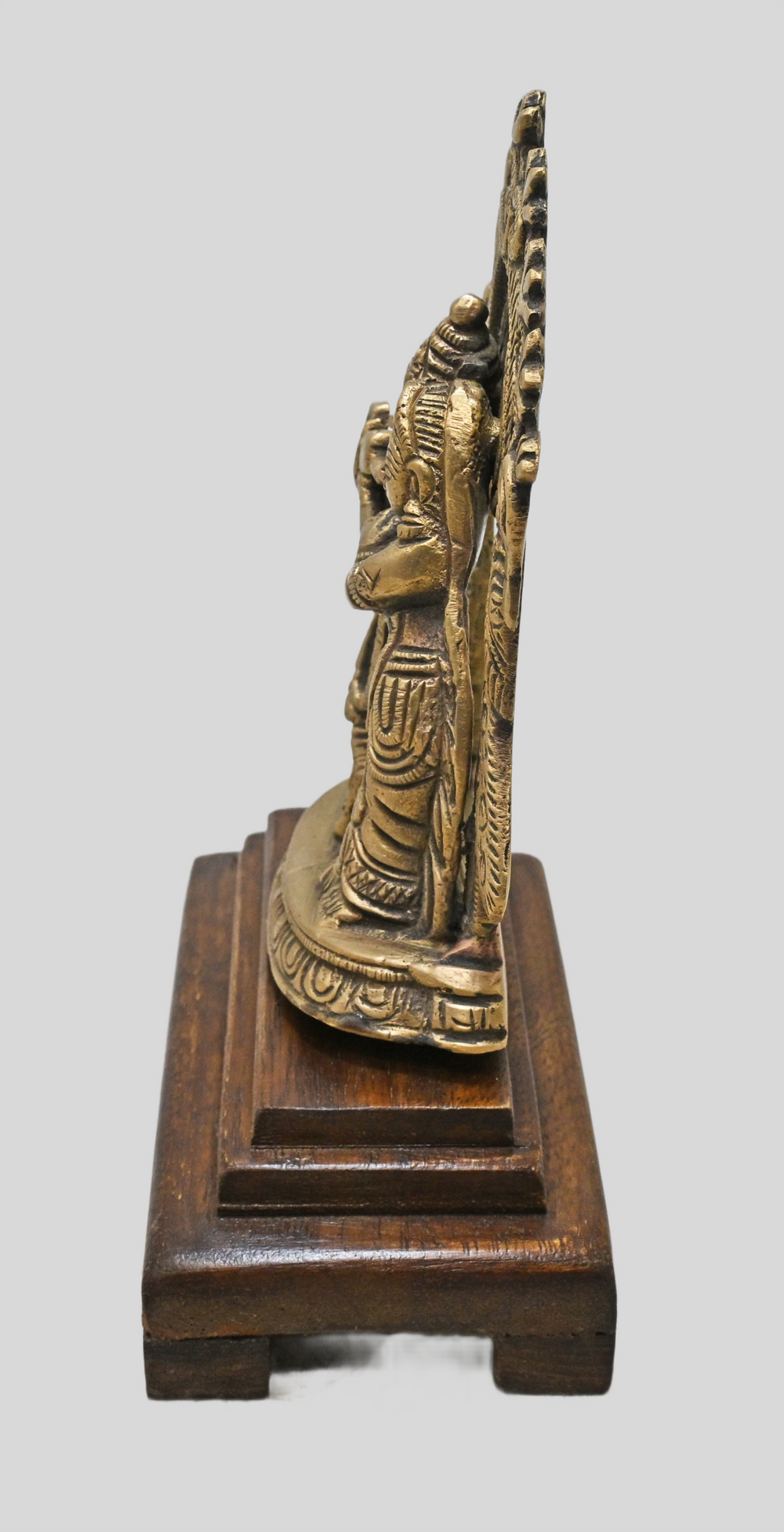 Close-up of Radha Krishna figures and flute details in brass