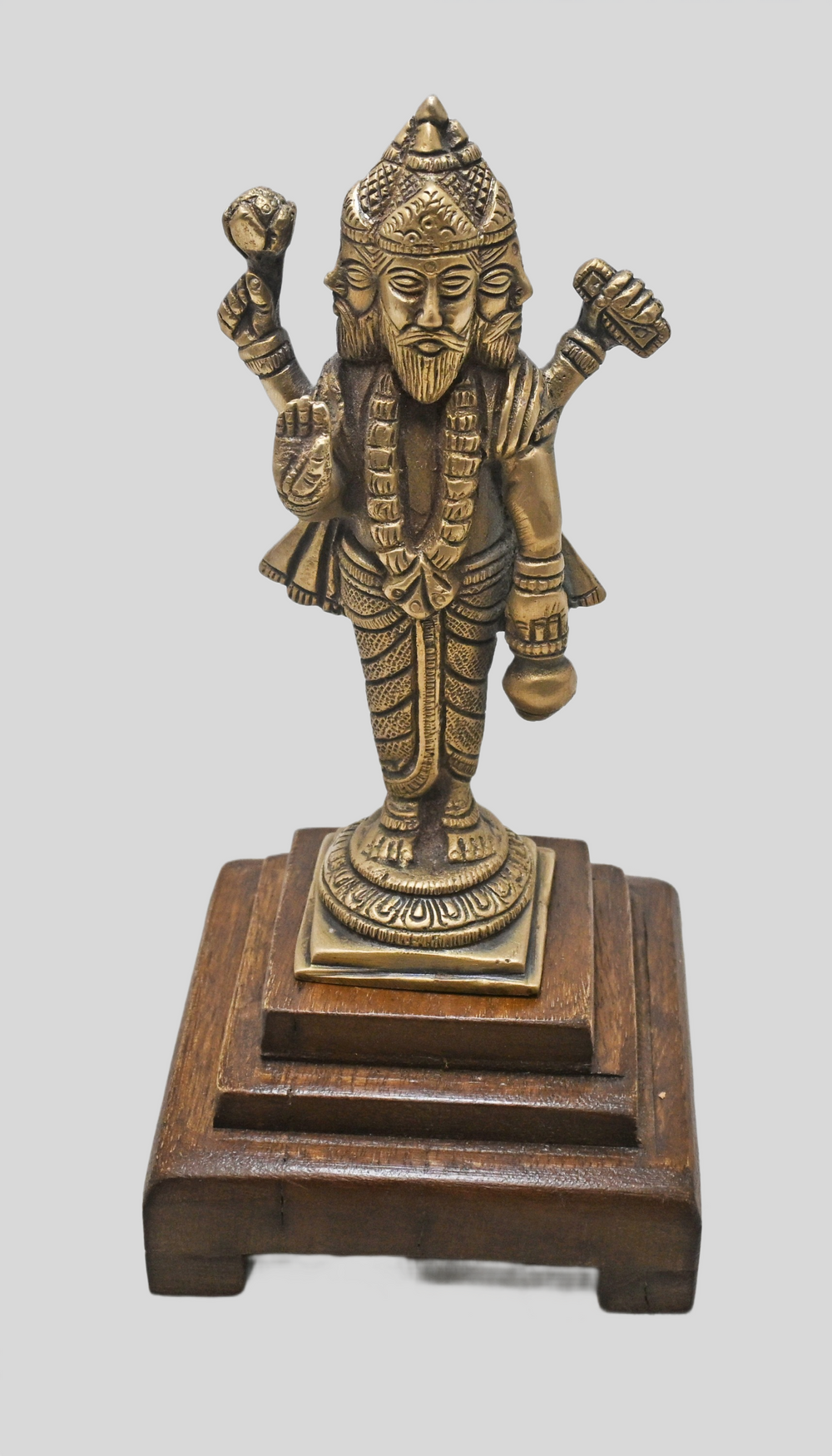 Brass Lord Brahma statue showing four faces, angled view