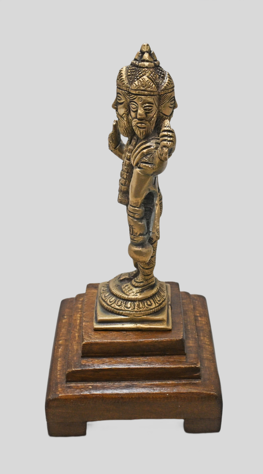 Close-up of the four faces and details on brass Lord Brahma statue