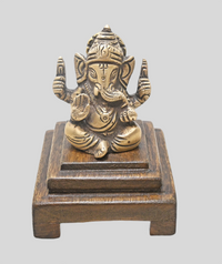 Brass Lord Ganesha statue showing detailed crown and ornaments, angled view