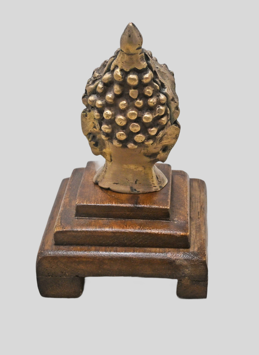 Brass Buddha bust showing wooden Bajot display base