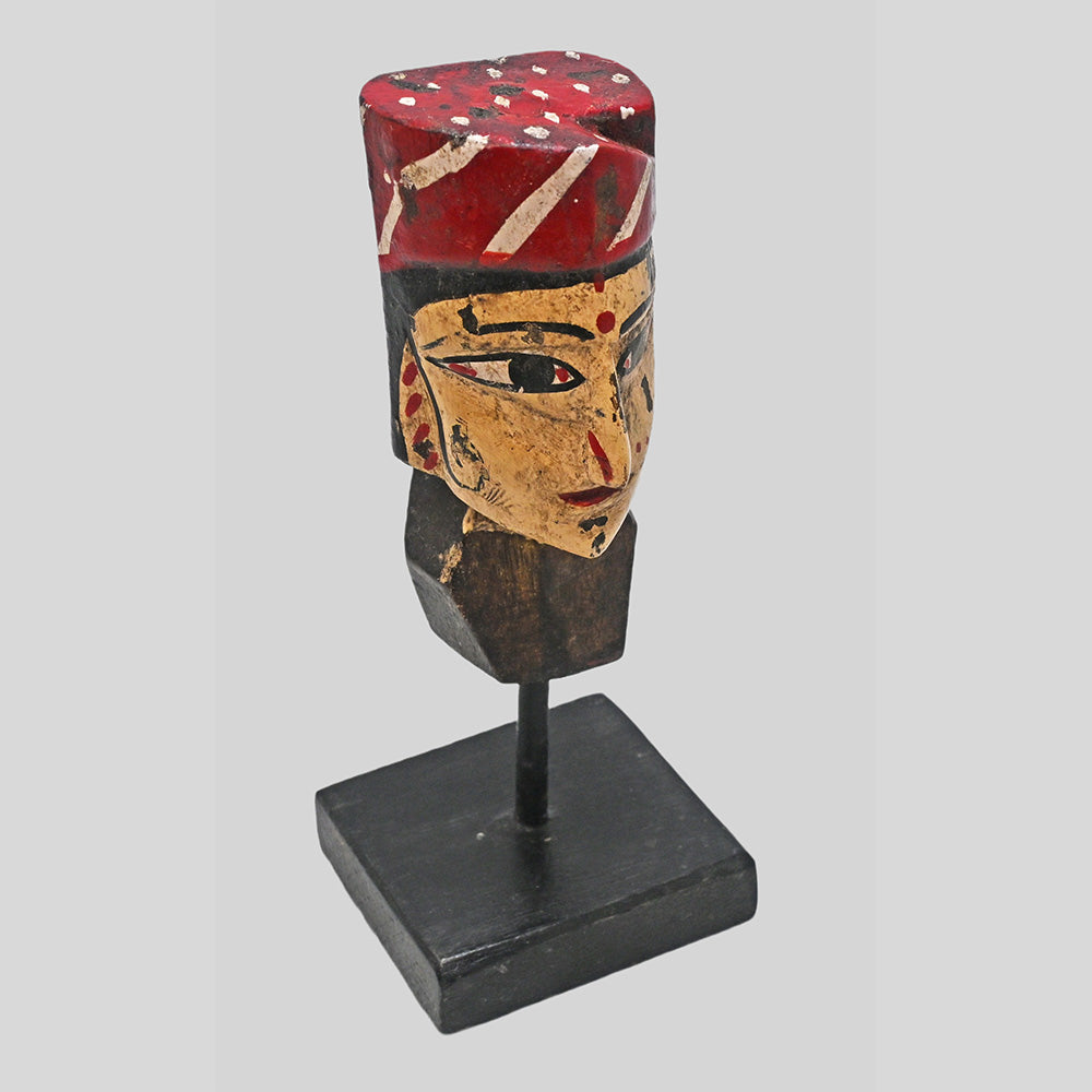 Angled view of vintage tribal queen bust sculpture with earthy painted details