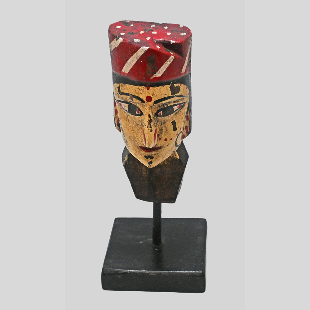 Close-up of painted facial details on handcrafted tribal queen bust