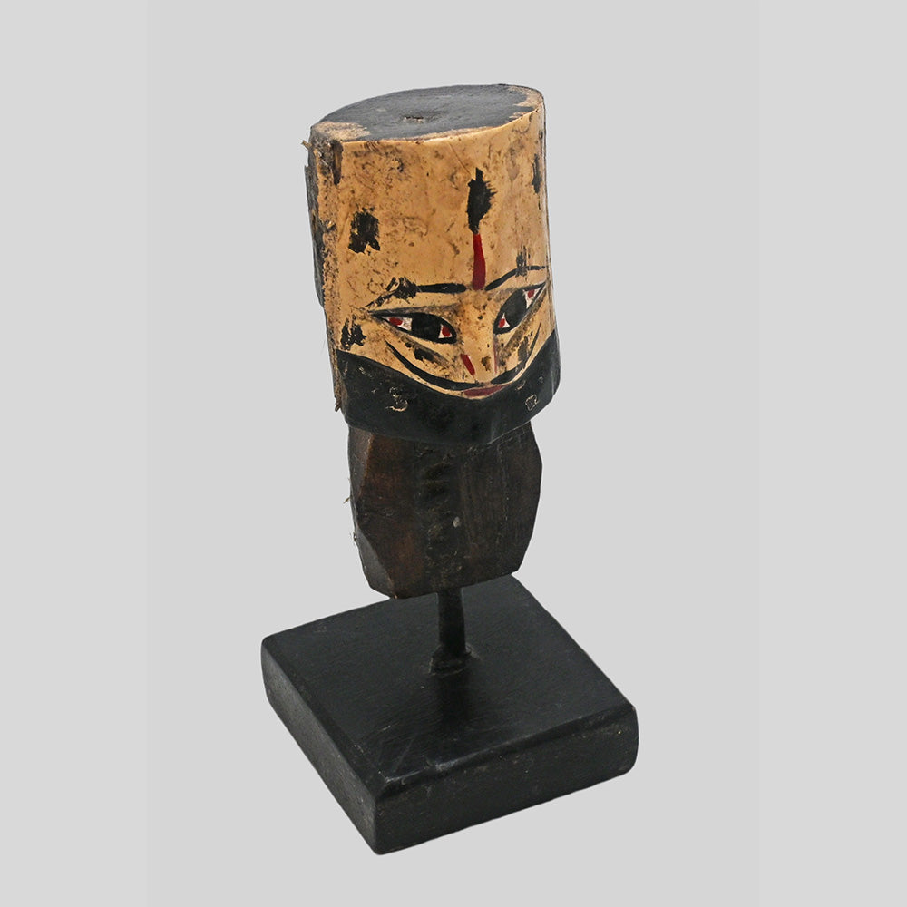 Angled view of vintage tribal king bust with earthy painted details