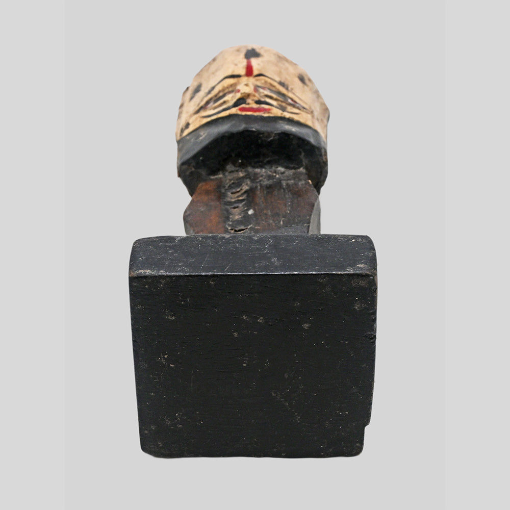 Rear view of handcrafted wooden tribal bust sculpture