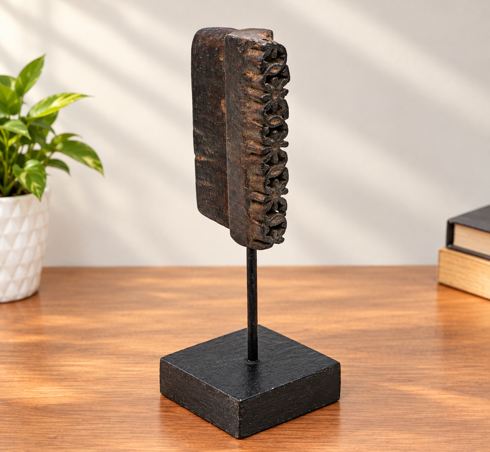 Deep-carved antique wooden textile printing block on stand, front view